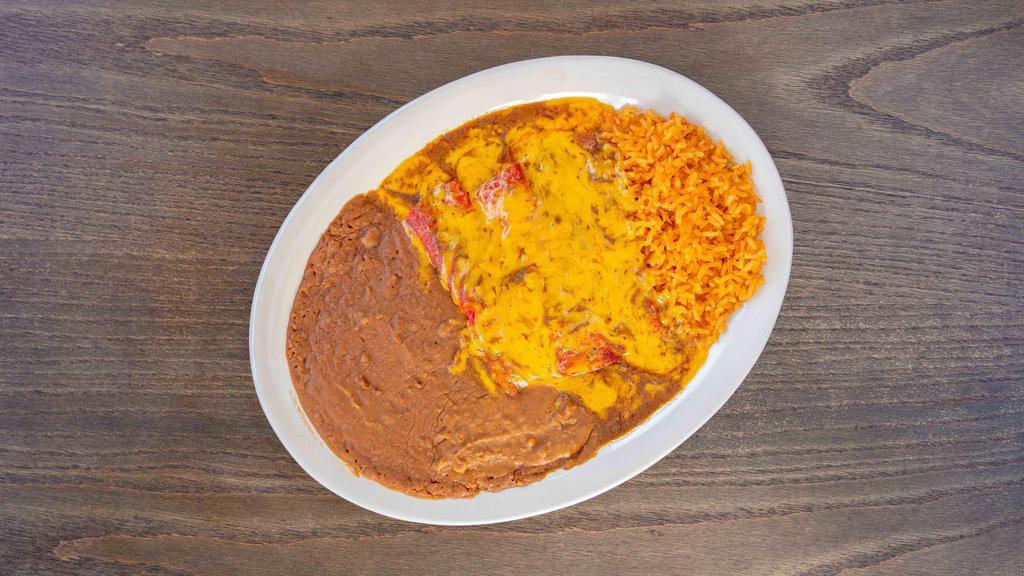 Enchiladas Rojas Plate · Three enchiladas in our homemade gravy and yellow cheese with filling, served with rice, beans, and tortillas.