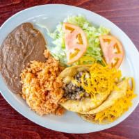 Puffy Tacos Plate · Two puffy tacos, served with rice, beans, and salad.