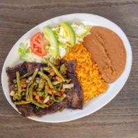 Carne Asada Plate · Deliciously grilled tender steak strip topped with nopalitos served with rice, beans, salad,...