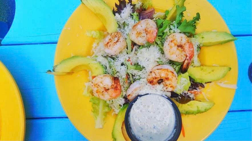 Texas Grilled Shrimp Salad · Grilled Texas Gulf shrimp, avocado, grated Romano cheese, cherry tomatoes, red peppers, boiled eggs, sweet red onions, shredded carrots, croutons & our signature creamy cilantro-lime dressing.