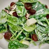 Backyard Salad · Baby spinach, aged white cheddar, spiced pecans, apples, and grapes. Served with a buttermil...