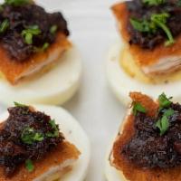 Gourmet Deviled Eggs · Our Gourmet Deviled Eggs consists of 4 deviled eggs topped with fried chicken schnitzel and ...