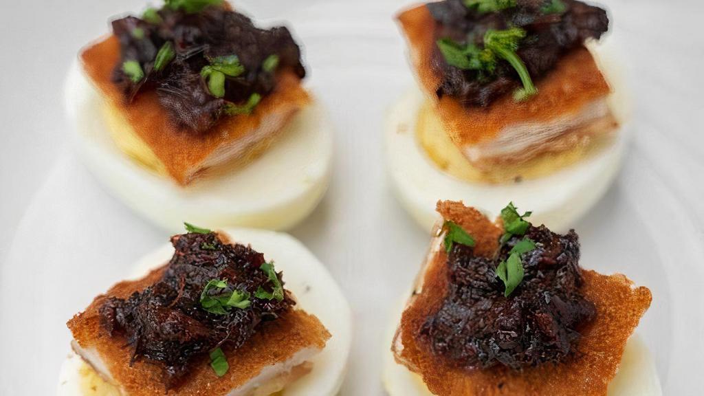 Gourmet Deviled Eggs · Our Gourmet Deviled Eggs consists of 4 deviled eggs topped with fried chicken schnitzel and our homemade Bacon Bourbon Jam.