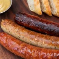 Sausage Sampler · Three authentic sausages German Bratwurst, Kasewurst(Cheese), and Spicy Kielbasa with baguet...