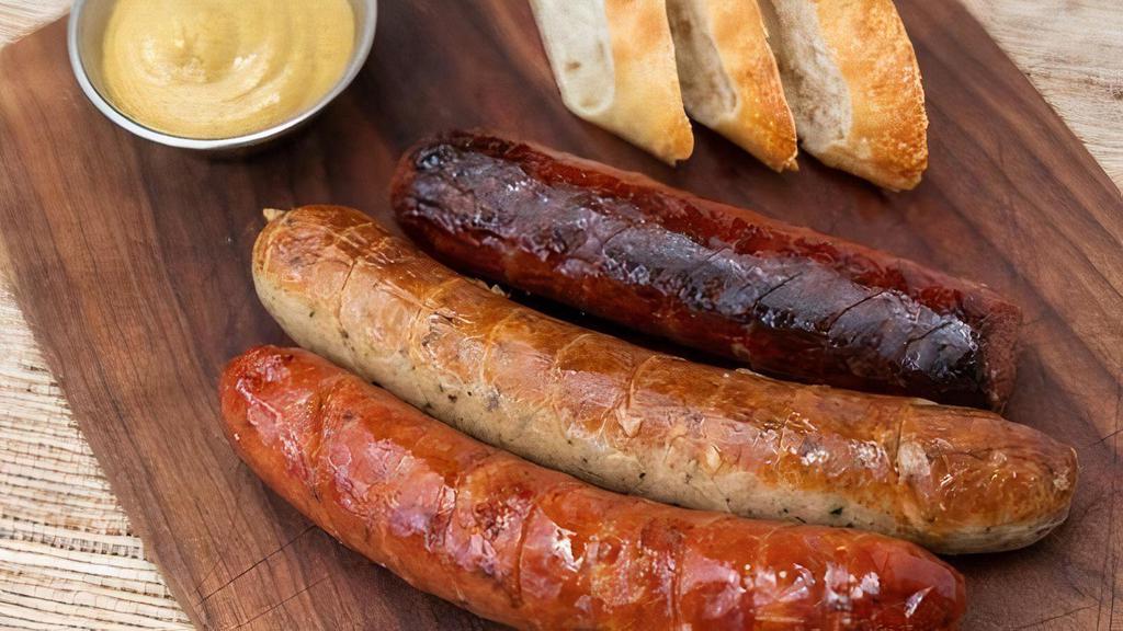 Sausage Sampler · Three authentic sausages German Bratwurst, Kasewurst(Cheese), and Spicy Kielbasa with baguette slices and king's mustard.