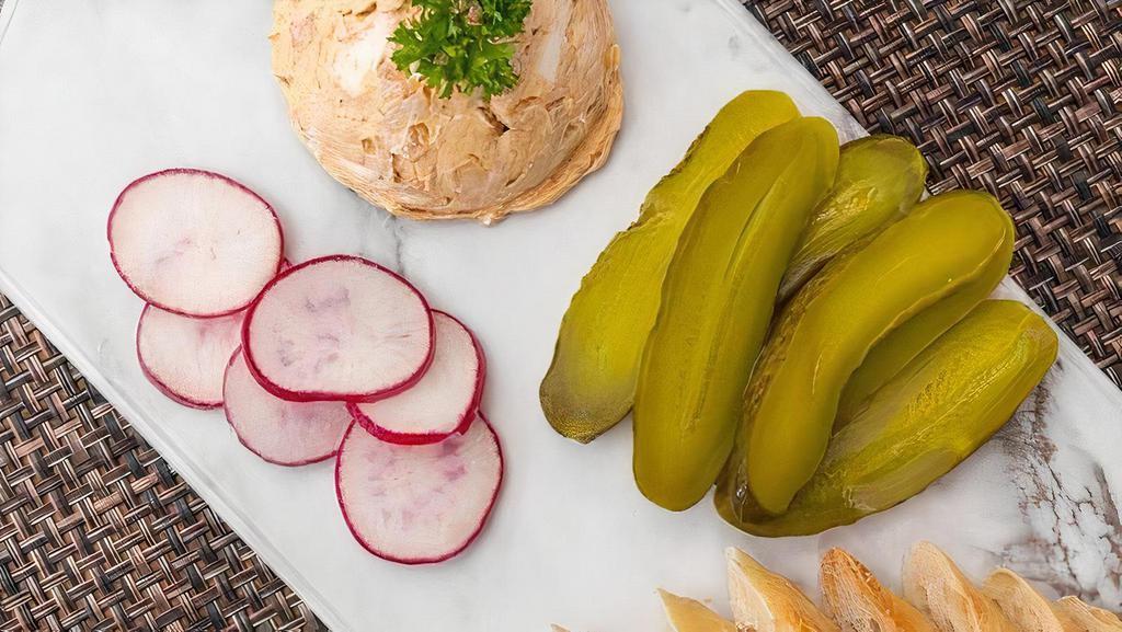 Liptauer Cheese Spread · Our delicious homemade spread is a blend of cream cheese, pickles, onions and paprika and served with French baguette slices and Pickle Slices.