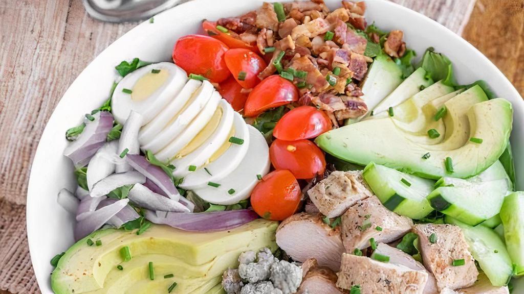 Chicken Cobb Salad · Romine lettuce, spring Mix, grape tomatoes, cucumber, bacon bits, fresh avocado, chives, Bleu cheese, cage free boiled egg, rosemary chicken breast, and Haus vinaigrette or any dressing of choice.