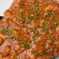 Cajun Schnitzel · Pork or Chicken Schnitzel topped with King’s Rice, homemade etouffee and Louisiana crawfish ...
