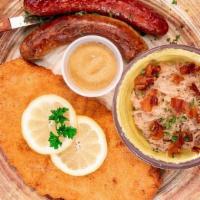Sausage And Schnitzel Plate · Includes two Traditional sausages and the guest’s choice of chicken or pork wiener schnitzel...
