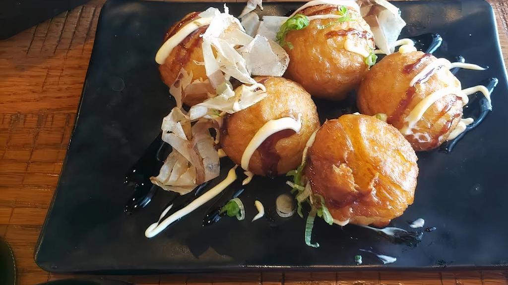 Takoyaki · 5 pieces. Baked octopus ball with mayo and eel sauce, dried fish flakes on top.