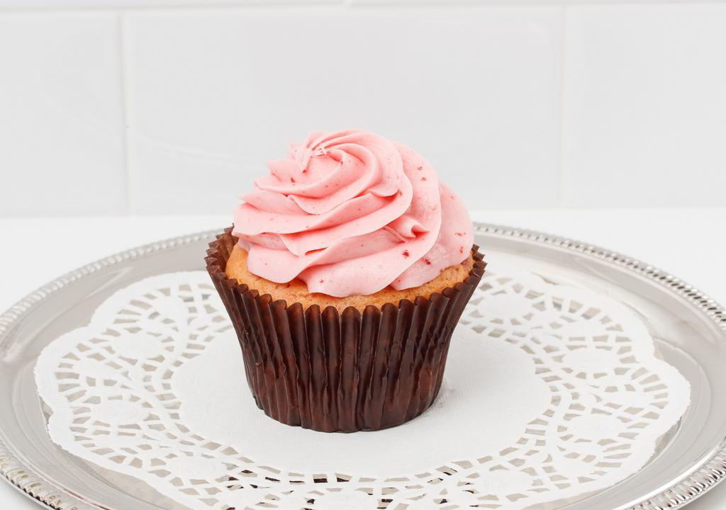 Strawberry Cupcake · Our strawberry cake topped with a swirl of our strawberry buttercream and a dollop of whip.