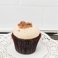 Peanut Butter Cup Cupcake · Our moist chocolate cake topped with peanut butter cream cheese frosting and chopped Reese’s...