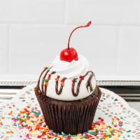 Sundae Cupcake · Our moist chocolate cake filled with fudge topped with vanilla buttercream, a fudge drizzle,...