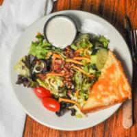 Legendary House Salad · Garden salad topped with bacon & cheese. Served with a piece of cheesy texas toast.