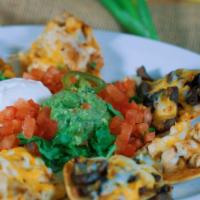 Nachos Compuestos · Our homemade chips topped with steak or chicken, black beans, melted cheddar and Monterrey j...