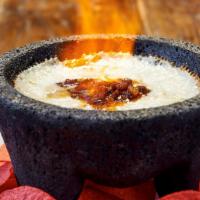 Queso Flameado · Melted oaxaca cheese topped with chorizo, grilled peppers and onion. Served flaming with war...