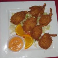 Camarones Coco · Hand dipped shrimp, tossed in shredded coconut, then fried till golden brown. Accompanied wi...