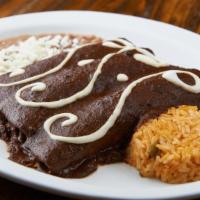 Enchiladas De Mole · Stuffed with chicken, mole poblano sauce and topped with mexican crema.