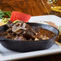 Lamb · Served with two sides of your choice of beans, rice, nopales or vegetables. Bone-in lamb, ru...