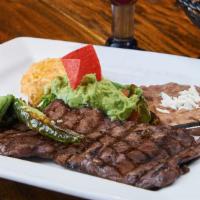 Carne Arrachera · Broiled thinly sliced skirt steak, served with jalapeño, grilled green onion, guacamole and ...