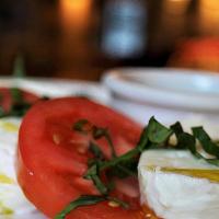 Tomato Mozzarella Salad Lunch · Heirloom tomatoes, fresh mozzarella cheese, and basil. Served with basil pesto.