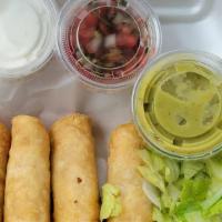 Flautas · Flautas made with flour tortillas filled with chicken or beef fajita served with rice and be...