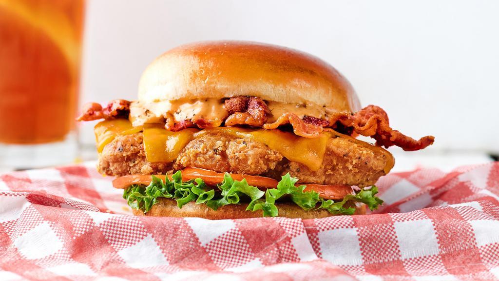 Amazin’ Club · Fried chicken, bacon, cheddar cheese, lettuce, tomato & Cluck Sauce