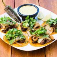 Street Tacos (5) · Corn tortillas, fajita, grilled onions, cilantro and taco sauce, a grilled jalapeño.