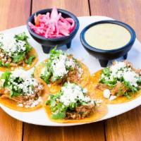 Cochinita Pibil Tacos (Pork Tacos) (4) · Corn tortillas,shredded pork, queso fresco, cilantro and habanero onions, taco sauce.