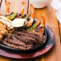 Plato Cancun (For Two) · Fajitas, four jumbo shrimp wrapped in bacon stuffed with Monterey cheese, peppers, and pinea...