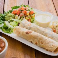 Tacos Al Carbon (2) · Flour tortillas stuffed beef or chicken fajitas and served with guacamole, queso blanco and ...