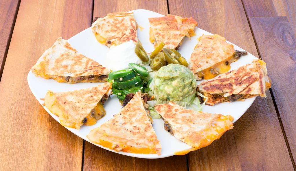 Spinach Quesadilla · Freshly sauteed spinach, guacamole, sour cream, and jalapeño.