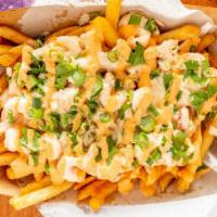 Reel Fries · Served with creamy Cajun shrimp and crawfish tails topped with onions, cilantro and Cajun ai...