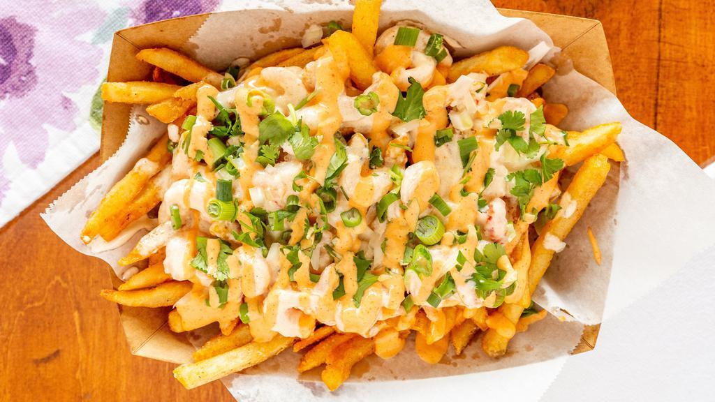 Reel Fries · Served with creamy Cajun shrimp and crawfish tails topped with onions, cilantro and Cajun aioli.