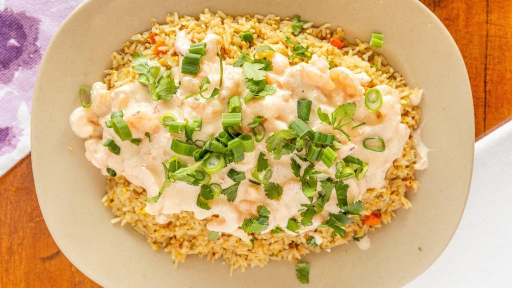 Reel Fried Rice · Served with creamy Cajun shrimp and crawfish tails topped with onions and cilantro.