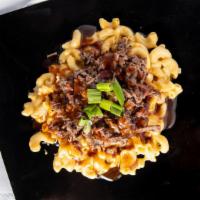 Brisket Mac · Mimi's Mac n Cheese topped with Brisket, with sauce, and chives.