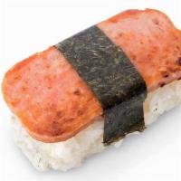 Spam® Musubi · Grilled SPAM® Musubi on top of a block of rice, wrapped together with nori