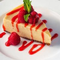 Ny Style Cheesecake · Creamy cheesecake with a graham cracker crust finished  with raspberry sauce and mint. Conta...