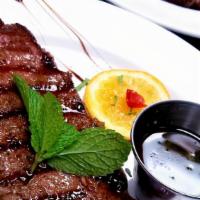New York Steak (8-10 Oz) · Eight to ten ounces. Grilled steak with sautéed onions and peppers.