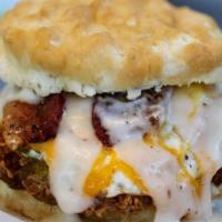 Ultimate Southern Chicken Biscuit · Golden fried chicken breast topped with an egg, bacon, cheese and gravy on a biscuit.