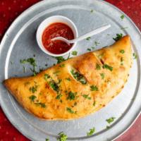 Meat Lovers Calzone · Stuffed with ricotta and mozzarella, up to three toppings of your choice.