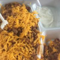 Frito Pie · Fritos, chopped beef, sauce and beans, cheese, and sour cream.