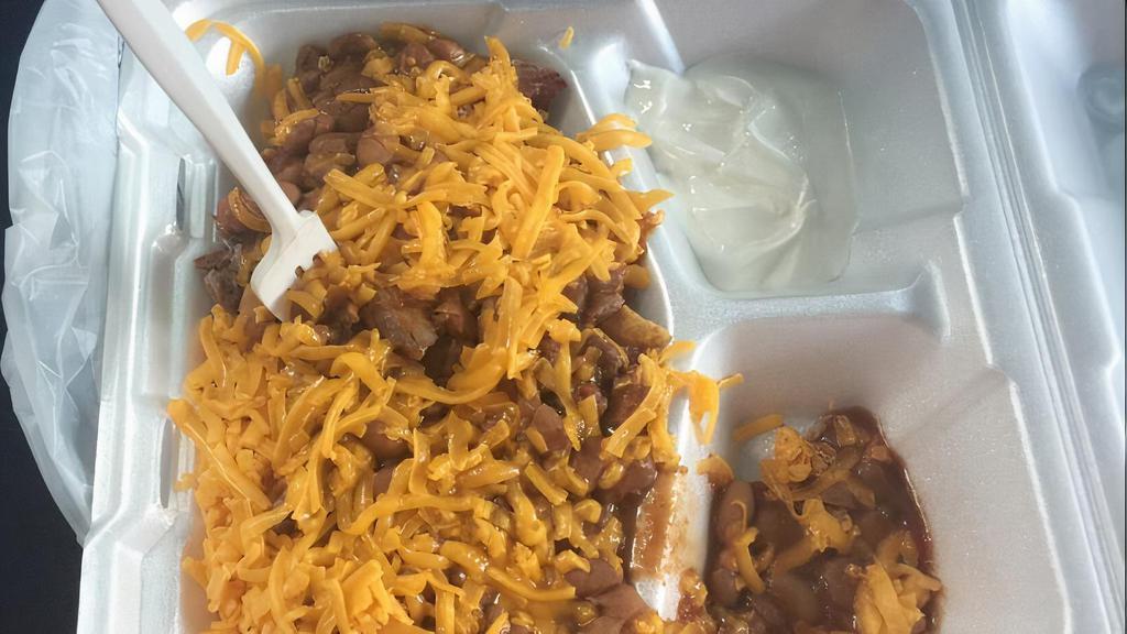 Frito Pie · Fritos, chopped beef, sauce and beans, cheese, and sour cream.