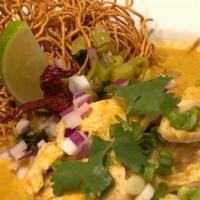 Khao Soi · Served spicy. Egg noodles in homemade curry with chicken, red onion, scallion, cilantro, and...