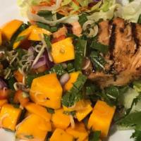 Mango Salmon Salad · 8 Oz. salmon marinated in thai herbs and spices; charcoal-grilled and served on top of a tha...