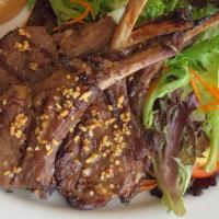 Gae Yang (Lamb Chops) · Grilled marinated New Zealand lamb chops, served with green salad and sticky rice.