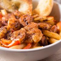 Cajun Pasta · Shrimp, chicken, andouille sausage, onions, peppers, penne pasta, Cajun cream sauce.