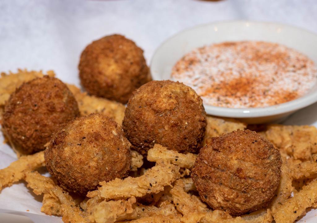 The Bomb · Five crispy fried balls, loaded with shrimp, cheddar jack cheese, roasted jalapenos, bacon, and green onions. Served on a bed of onion strings with buttermilk ranch.