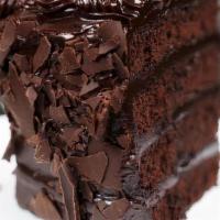 Chocolate Fudge Cake · Moist chocolate fudge cake, layered with rich buttercream, covered in milk chocolate shavings