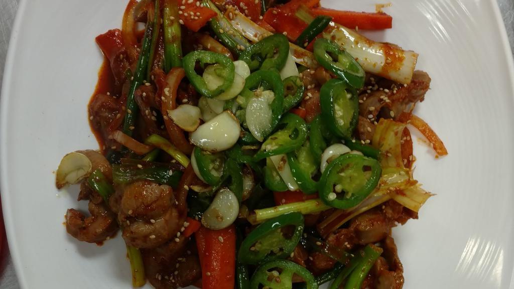 Spicy Stir Fry Chicken Feet · Stir fried chicken feet with onions, carrot and green onion.